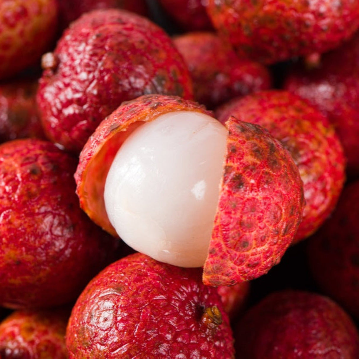 Mauritius Lychee open to show the white flesh of the fruit.