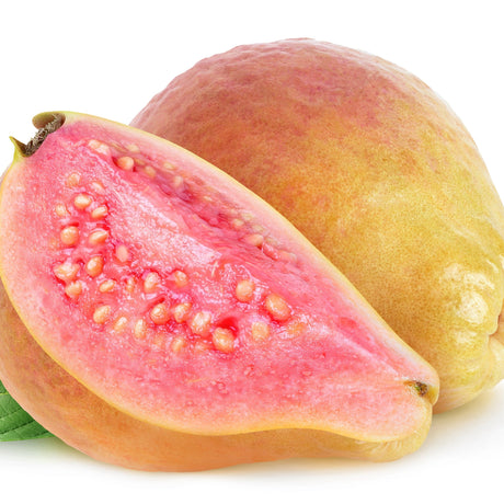 One full guava fruit which has a yellow skin mixed with a blushing pink color at its base sitting next to a sliced guava exposing its bright pink center and yellow seeds.