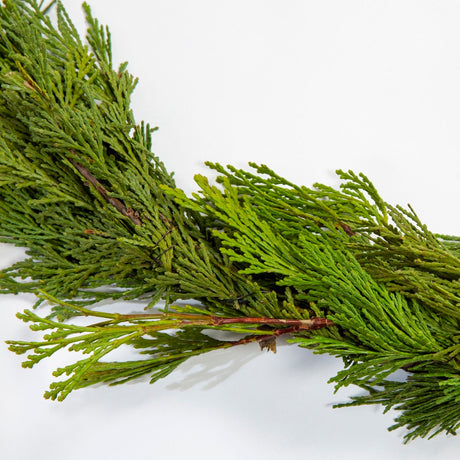 Close up view of the fresh cut cedar garland showing one of the subtle floral wire connections between the branches