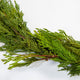 Close up view of the fresh cut cedar garland showing one of the subtle floral wire connections between the branches